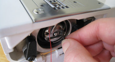Comment insérer un fil, une aiguille double, une canette dans une machine à coudre?